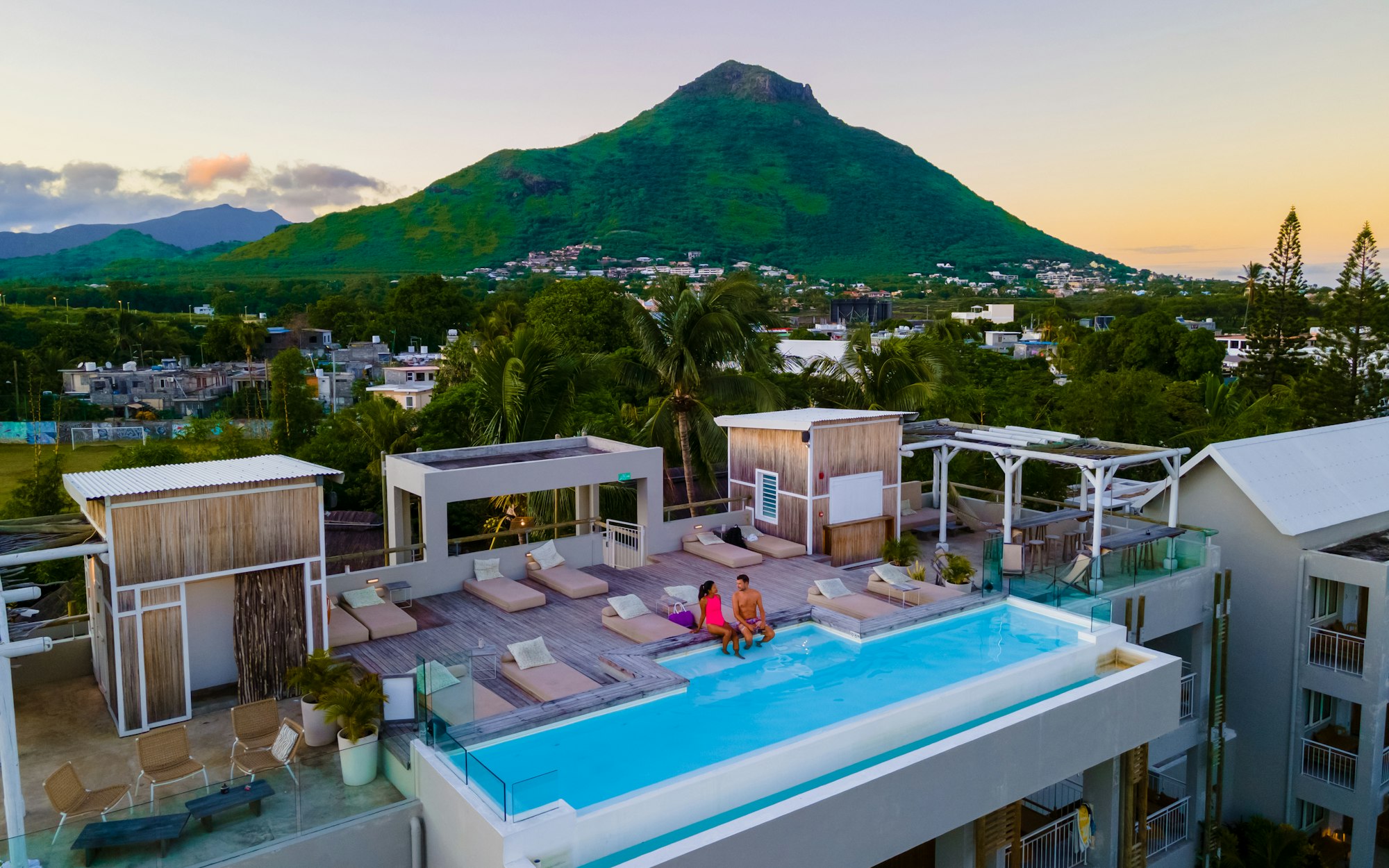 Man and Woman relaxing in a swimming pool, a couple on a honeymoon vacation in Mauritius Man and Woman relaxing in a swimming pool, a couple on a honeymoon vacation in Mauritius